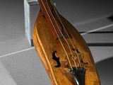 a violin that is sitting on a stand on the floor