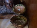 many plates and bowls sitting on a table next to a mirror