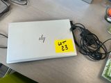 a laptop with a yellow sticker on it sitting on a desk
