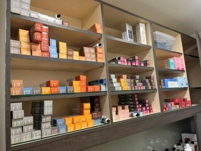 many boxes of cigarettes on the shelves in the store