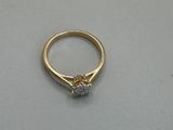 a close up of a gold ring with a diamond on it