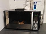 a microwave sitting on top of a table in a room