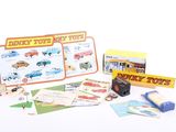 a box of toy cars and other items on a white surface