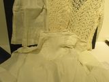 a bed with a lot of white clothes on it