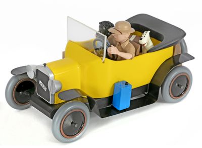 a yellow toy car with a man and a dog in it