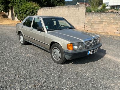 a silver car that is parked in a parking lot