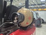 a close up of a forklift with a gas can attached to it