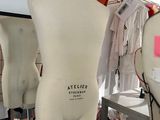 three mannequins on display in a clothing store