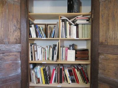 a book shelf with many books on it in a room