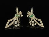 a pair of emerald and diamond earrings