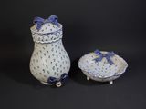 pair of blue and white porcelain vases and a bowl on a black background