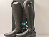 black leather riding boots with a black box on a white surface