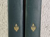 two books sitting on top of a table next to each other