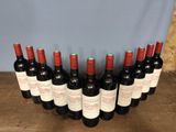 six bottles of red wine lined up on a wooden table