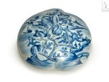 a blue and white plate with a picture of a dragon on it