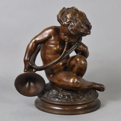 bronze statue of a boy with a bell on a marble base
