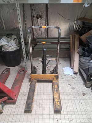 a picture of a forklift in a garage with a lot of tools