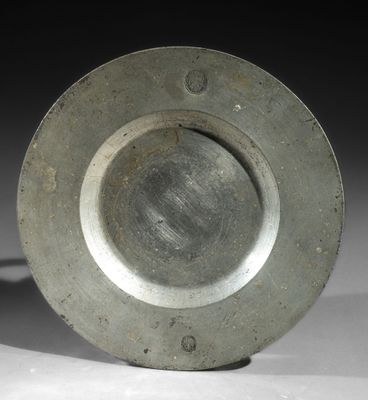 a silver plate sitting on top of a white table