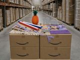 a carton with a pineapple on top of it in the middle of a warehouse
