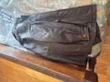 a black leather jacket sitting on top of a wooden table
