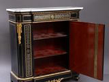 an antique black and gold painted cabinet with a door open