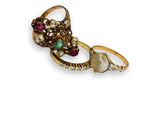an image of a pair of gold rings with pearls and gems