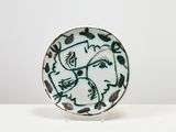 an image of a plate with a bird on it sitting on a table