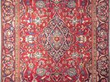 an antique persian rug with red and blue colors