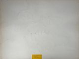 an old photo of a white wall with a yellow label on it
