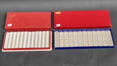two boxes of cigarettes are sitting on a table next to each other