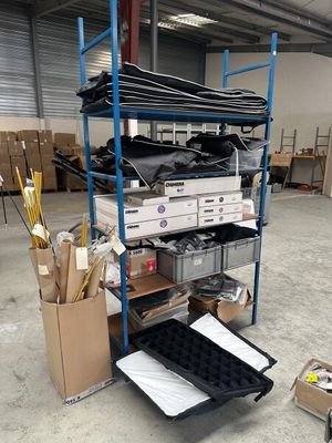 a cart with many different items in it in a warehouse