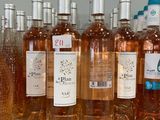 several bottles of wine are lined up on a counter