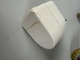 a white toilet with a white tank and a red stop button