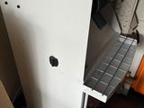 a white refrigerator sitting in a room next to a wall