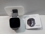 a smart watch sitting on a table next to an apple watch