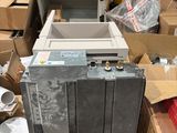 a pile of boxes and a refrigerator in the middle of a warehouse