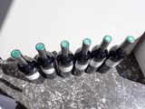 several bottles of wine are lined up on a table