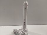 a toothbrush that is sitting on a table next to a charger