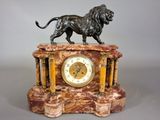 a statue of a lion on top of a clock
