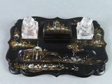 a black tray with two salt and pepper shakers on it