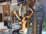 a statue of a deer on a pedestal in a room