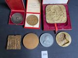 a lot of gold and silver coins in a red box
