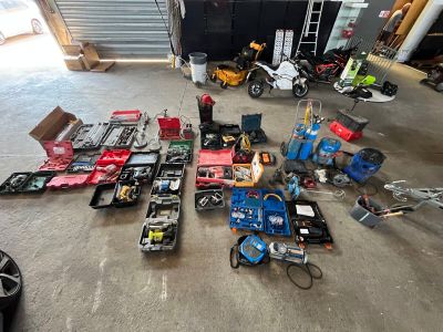 a lot of assorted items on the floor in a garage