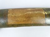 a baseball bat with a wooden handle on a white surface