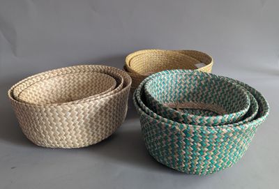 three woven baskets sitting on top of a table next to each other