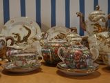 many different types of tea cups and saucers on the table