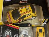 a yellow toy car in a box with a remote control