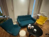 a living room with a couch, chair, table and coffee table