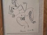 framed picture of a drawing of a woman sitting on a chair