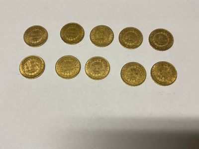 a bunch of gold coins sitting on top of a white table